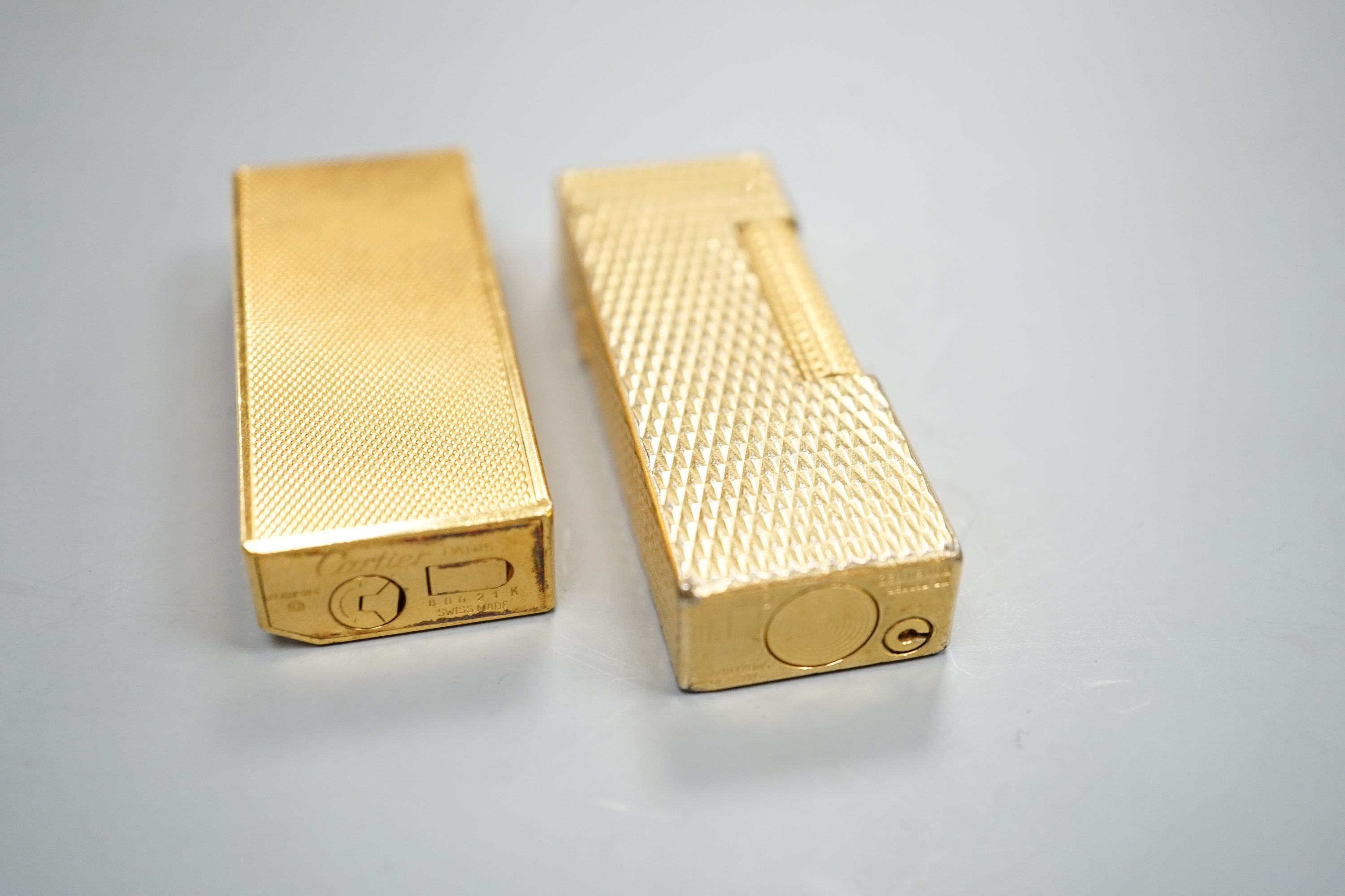 A gold plated Cartier lighter and a similar Dupont lighter